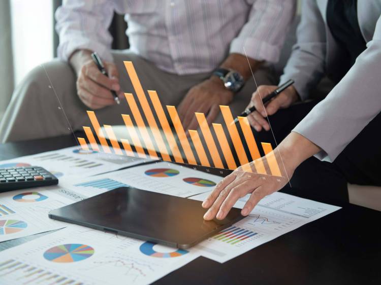 Two fiduciary financial Investors looking at investment and diversified portfolio data