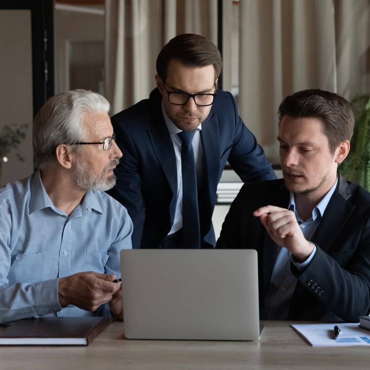 Three generations of family men members discussing family office matters