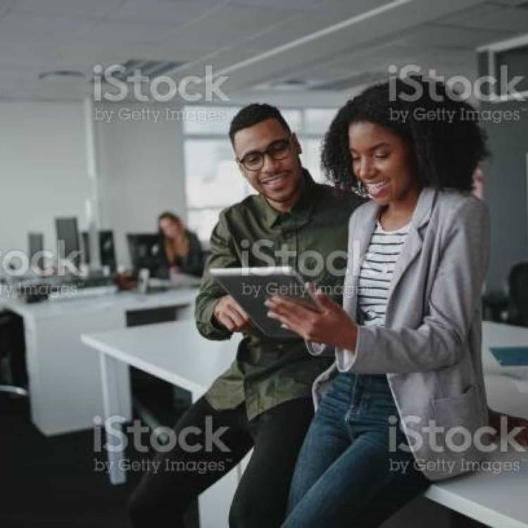 Two colleagues both looking at an ipad