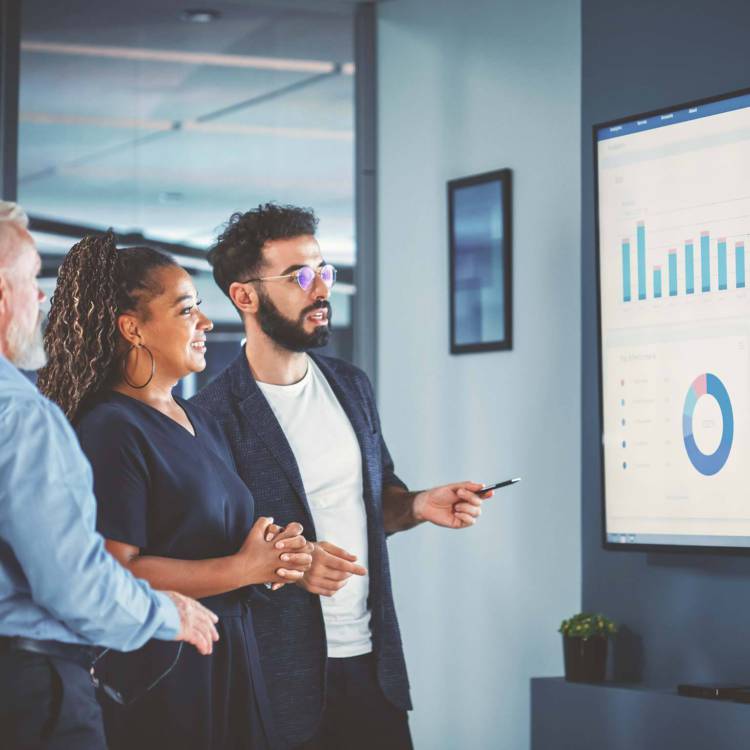 Three executives reviewing and discussing financial and wealth management