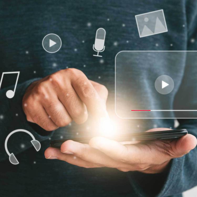 Person holding a phone with holographic elements floating around it, such as a music note, microphone, a photo, headphones and a play button