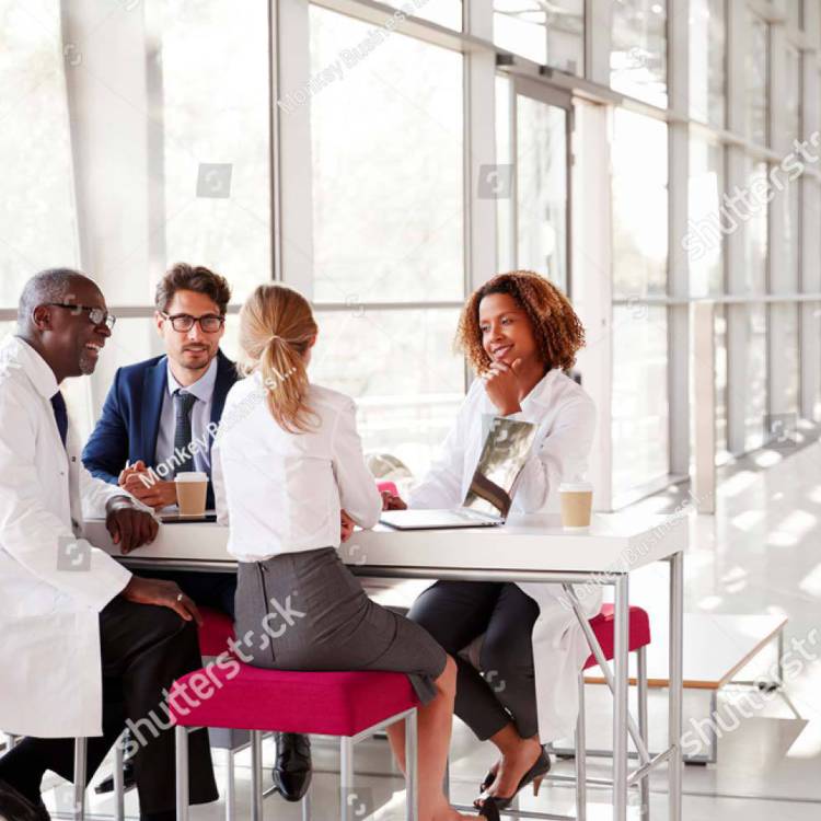 Doctor medical professionals sitting around a table discussing health care matters