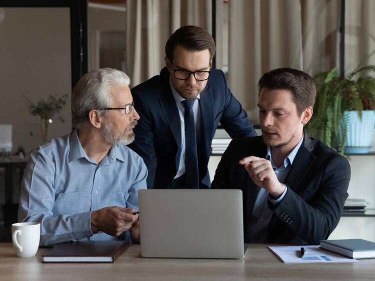 Three generations of family men members discussing family office matters