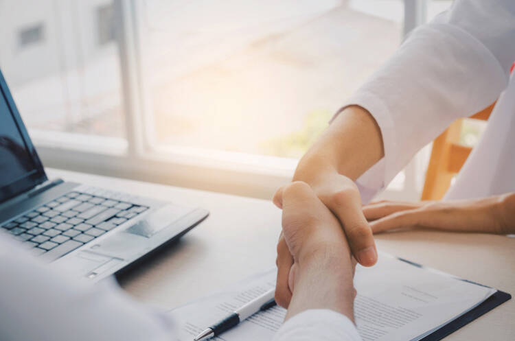 Financial Advisor Shaking Hands With Client