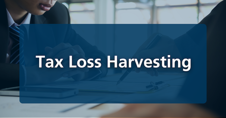 Tax loss harvesting wording overlaid on a photo of a fiduciary investment and financial advisor discussing wealth management