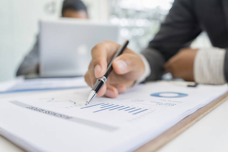 Fiduciary investment advisor looking over financial diversified portfolio documents
