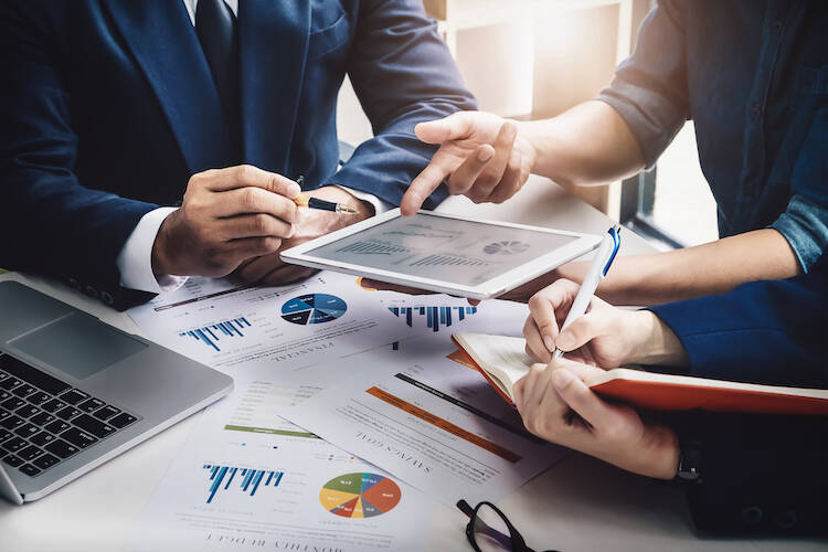 A unified team of financial advisors discussing financial planning about wealth management and client portfolios.