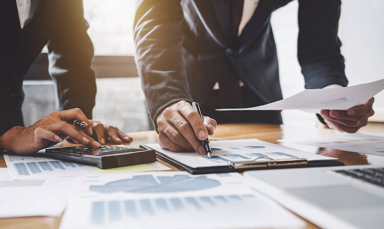 Two fiduciary investment advisors looking over documents to find a balance in diversification