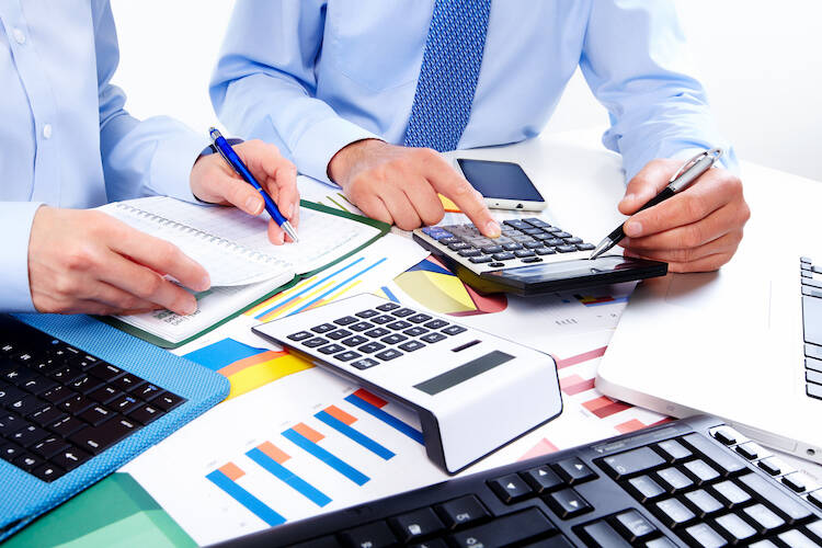 Two fiduciary investment and financial advisors discussing and going over diversified portfolio information