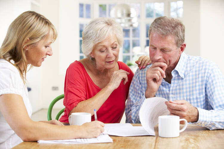 Retired couple reviewing financial documents about investing