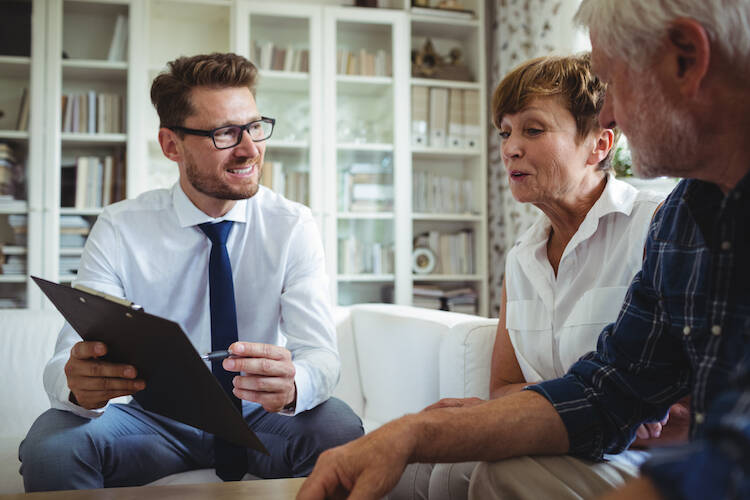 Retired senior couple discussing financial matters with fiduciary investment advisor