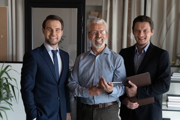 Three generations of family men members representing family office dynamic